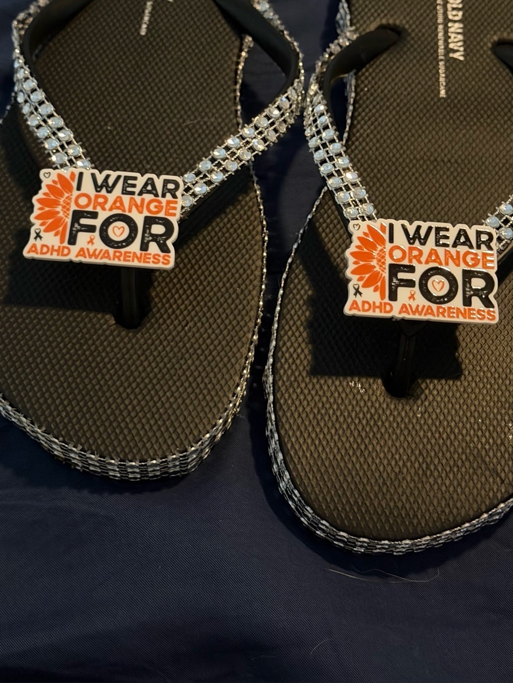 Womens Black Rhinestone Flip Flop Sandals with Orange Awareness Charm